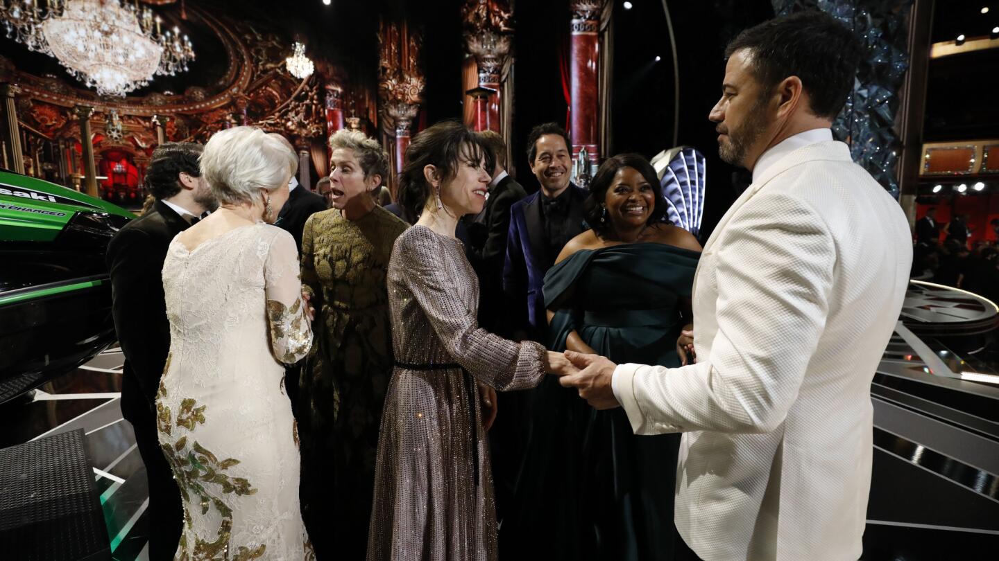 Host Jimmy Kimmel chats with Sally Hawkins and Octavia Spencer as Helen Mirren and Frances McDormand talk nearby backstage at the Oscars.