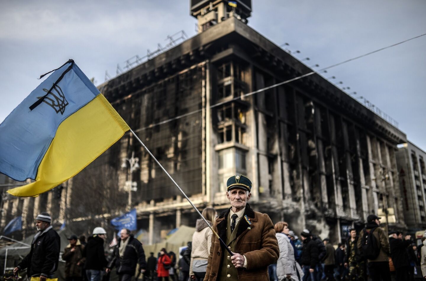A man stands with an Ukrainian flag in Kiev's Independence Square.