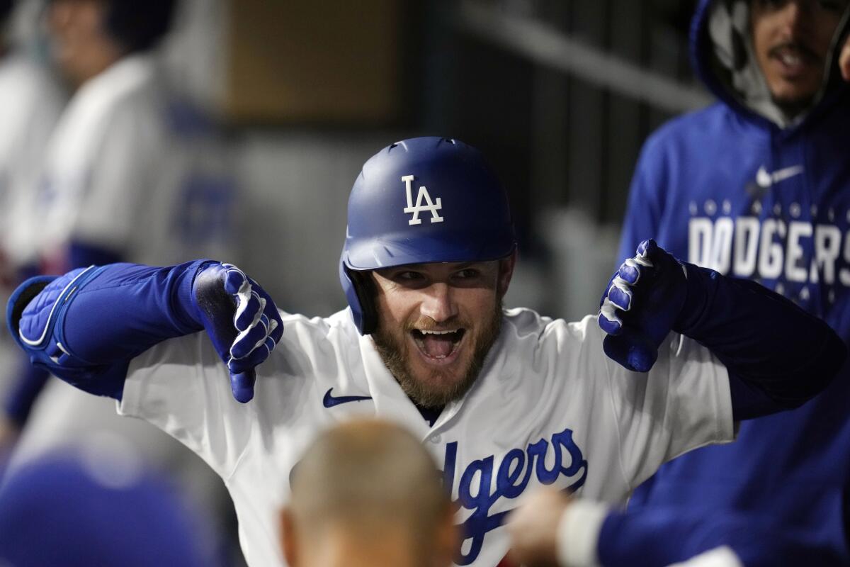 Dodgers' Max Muncy celebrates his solo home run against the Colorado Rockies during the fourth inning at Dodger Stadium.