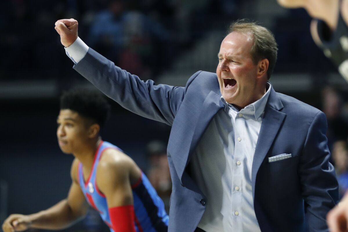 FILE - In this Dec. 3, 2019, file photo, Mississippi coach Kermit Davis gestures to his players during the second half of an NCAA college basketball game against Butler in Oxford, Miss. Davis took Mississippi back to the NCAA Tournament in his first season two years ago. He’s banking heavily on transfers for any chance to make another run. The Rebels, who must replace high-scoring guard Breein Tyree, brought in three Division I transfers to bolster a roster led by starting guard Devontae Shuler. (AP Photo/Rogelio V. Solis, File)