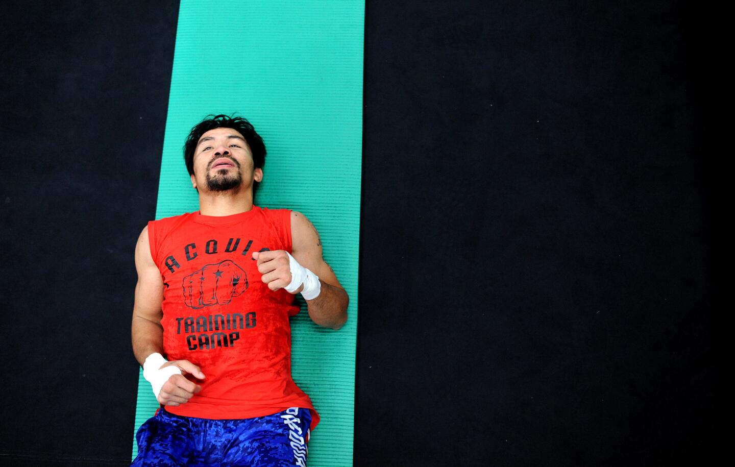 Boxer Manny Pacquiao does sit-ups during a workout at the Wild Card Boxing Gym in Los Angeles.