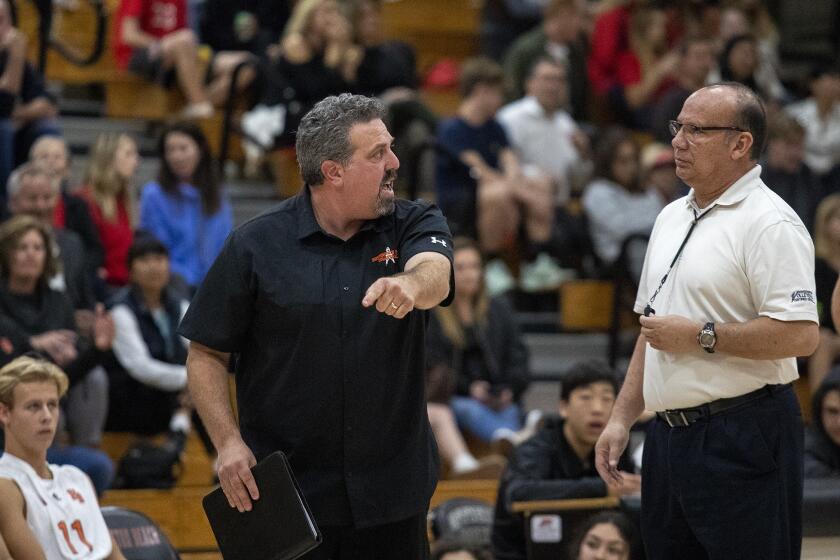 Huntington Beach's coach Craig Pazanti argues an out call with the referee during a nonleague match against Mater Dei on Wednesday, February 27.