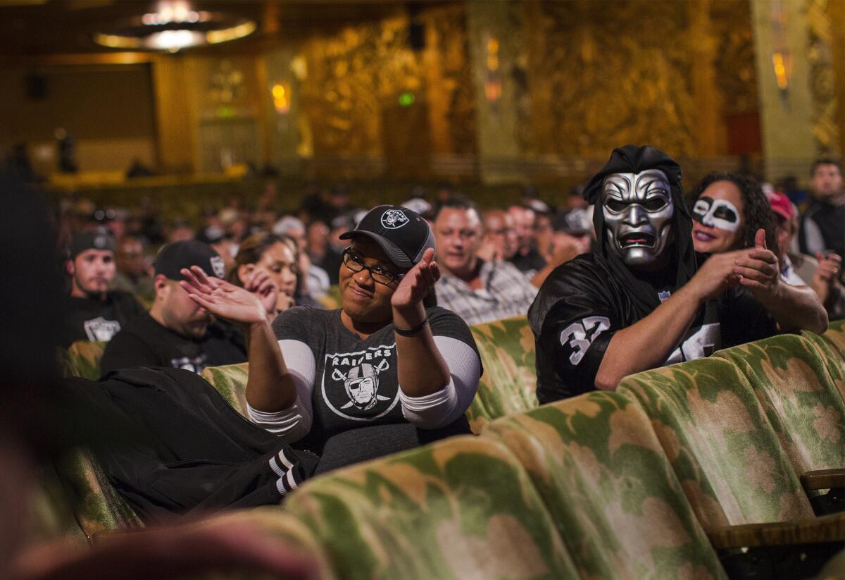 Raiders fans in Oakland cheer as team owner Mark Davis speaks during an NFL hearing on possible relocation to L.A.