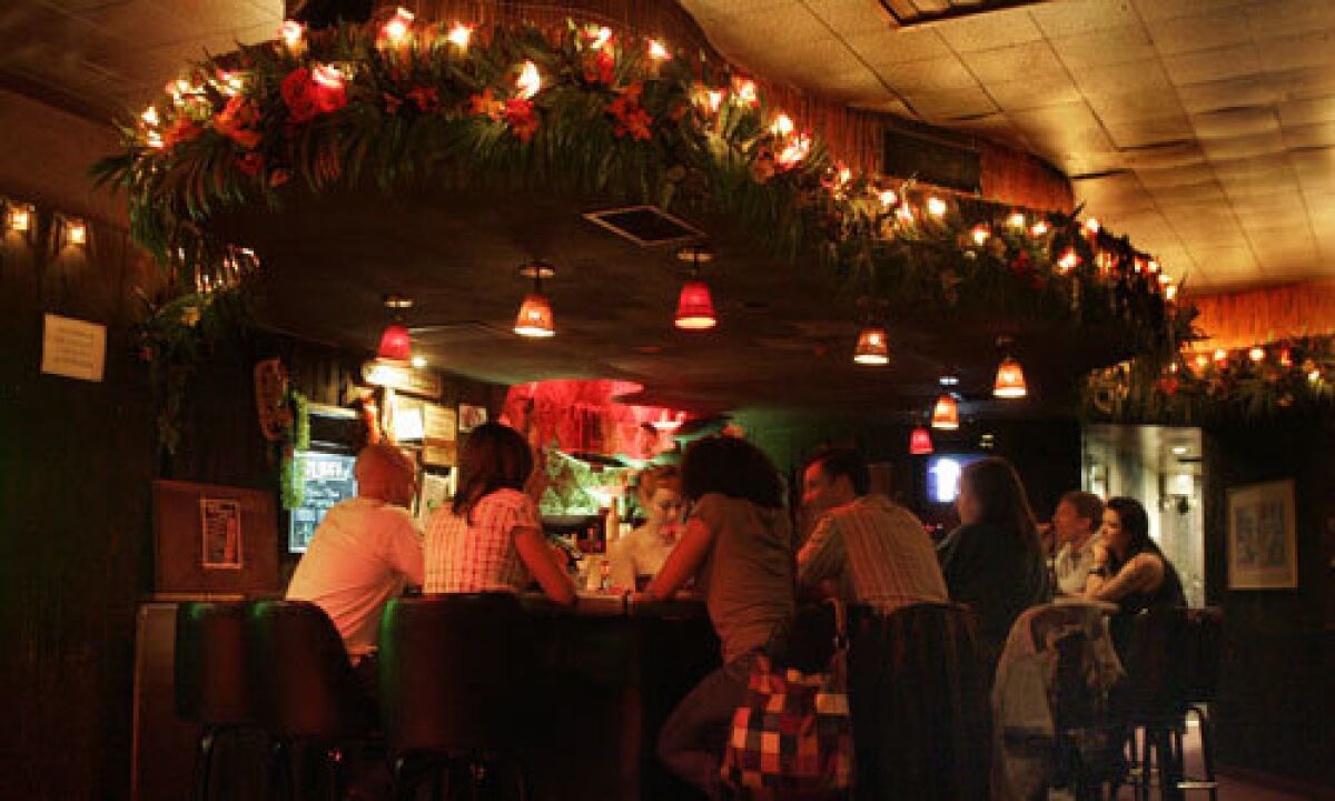 ISLAND FEVER: Loyal patrons fill the bar at the colorful yet little-known Tonga Hut, which has been restored to its 1960s glory by current owners Ana Reyes and Jeremy Fleener.