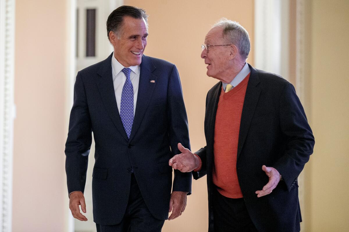 Republican Sens. Mitt Romney of Utah, left, and Lamar Alexander of Tennessee.