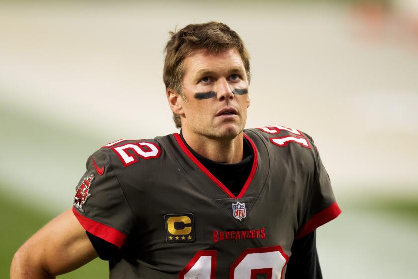 Tampa Bay Buccaneers quarterback Tom Brady (12) jogs off the field after defeating the Denver Broncos.