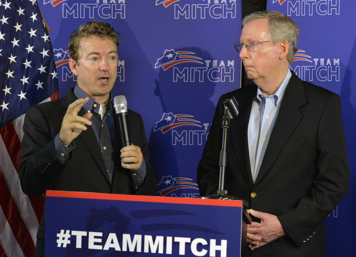 Kentucky Sens. Rand Paul, left, and Mitch McConnell address the media during a news conference after McConnell's victory in the Republican primary. Both are opposed to President Obama's proposal for cutting carbon emissions.