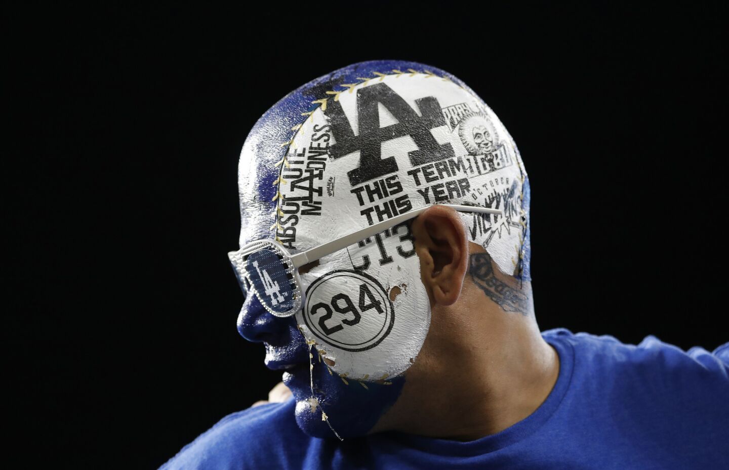 Fan Angel Rodriguez of East Los Angeles wears his Dodgers pride on his face while watching Houston win 7-6 in the 11th inning to even the series.
