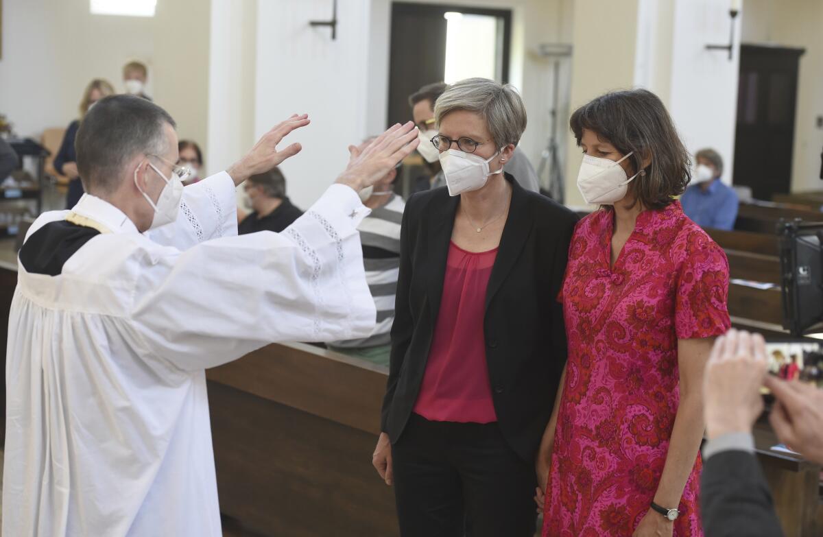 Vicar blessing lesbian couple in a church