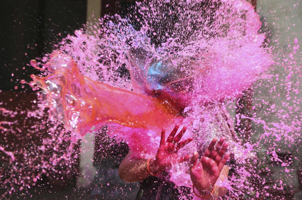 Indians play with colored water during Holi festivities in Allahabad, India. (Rajesh Kumar Singh / Associated Press)