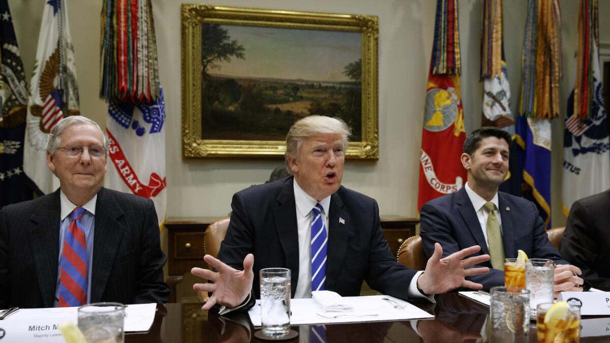 President Trump is flanked by Senate Majority Leader Mitch McConnell (R-Ky.), left, and House Speaker Paul D. Ryan (R-Wis.) at the White House.