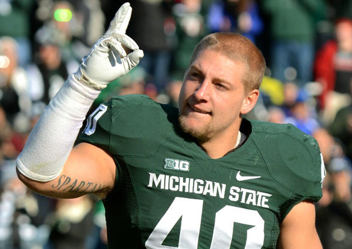 Michigan State linebacker and captain Max Bullough waves to fans during player introductions before a game against Minnesota last month.