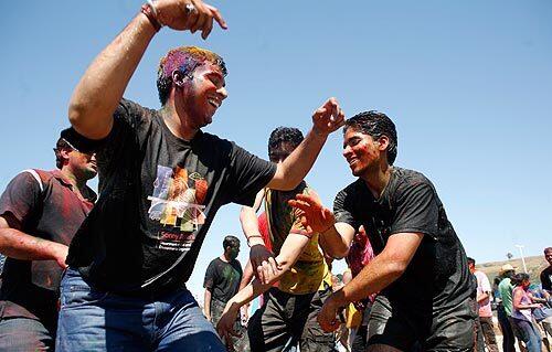 At Dockweiler State Beach, USC students celebrate the Indian national holiday of Holi, in which people splash each other with paint and colored dust. More than 1,500 Indian citizens are now full-time students at the campus, and with more than 83,000 last year at U.S. schools, they are the largest group of international students in the country.