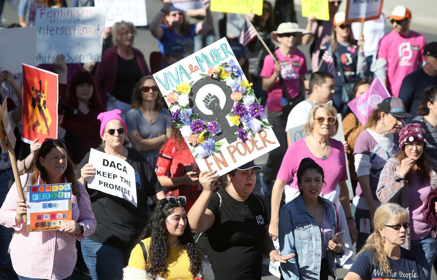 A mass of marchers, signs held high, proceed down Civic Center Drive. Demonstrators were participating in last week's Orange County Women's March in downtown Santa Ana.