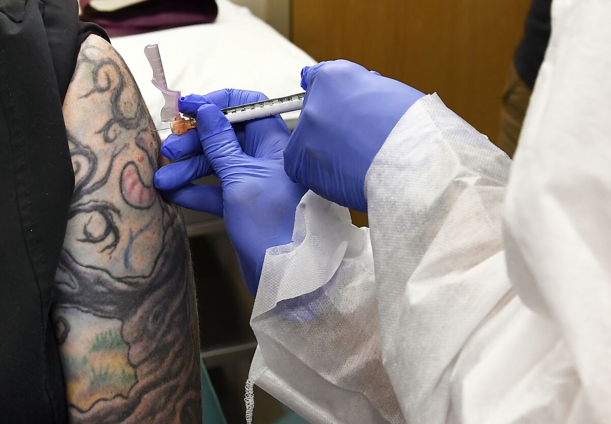 A volunteer receives an injection of Moderna's experimental COVID-19 vaccine.