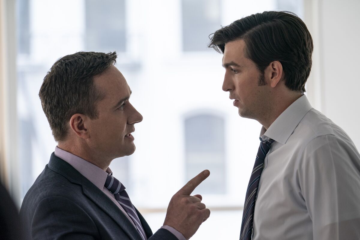 Matthew Macfadyen, left, stands facing and pointing at Nicholas Braun in HBO's "Succession."
