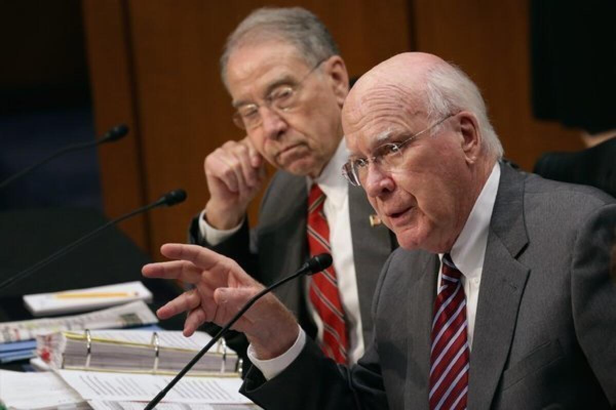Senate Judiciary Committee Chairman Patrick Leahy (D-Vt.), right, and ranking member Sen. Charles Grassley (R-Iowa) debate on Capitol Hill during a markup session for the immigration reform legislation.