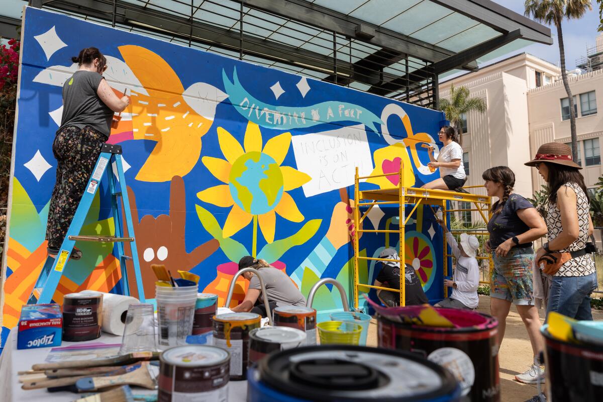 Voluntarios y artistas con discapacidades del desarrollo pintan un mural que celebra la diversidad