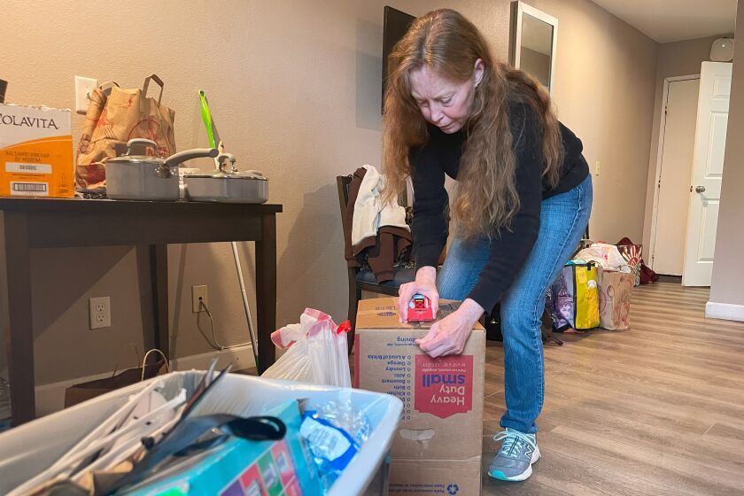 Annie Malloy packs up the motel room she was living in, in early March, to move. 