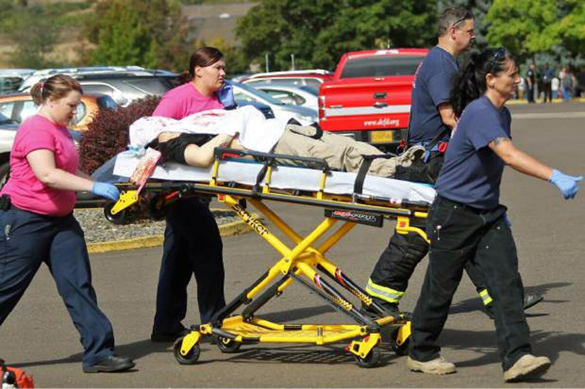 Authorities carry a shooting victim away from the scene after a gunman opened fire Thursday at Umpqua Community College in Roseburg, Ore. Yes, yet another mass shooting in America.