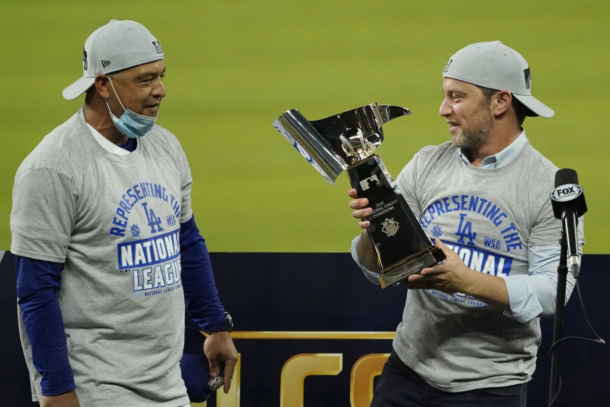 Andrew Friedman holds the trophy after the Dodgers' victory in the 2020 National League championship series.