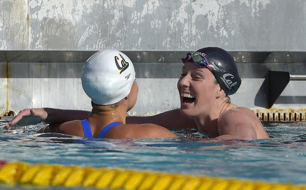 Missy Franklin, left, hugs Natalie Coughlin, right, after winning the women's 100 meter freestyle at the Los Angeles Invitational swimming meet at USC on July 18.