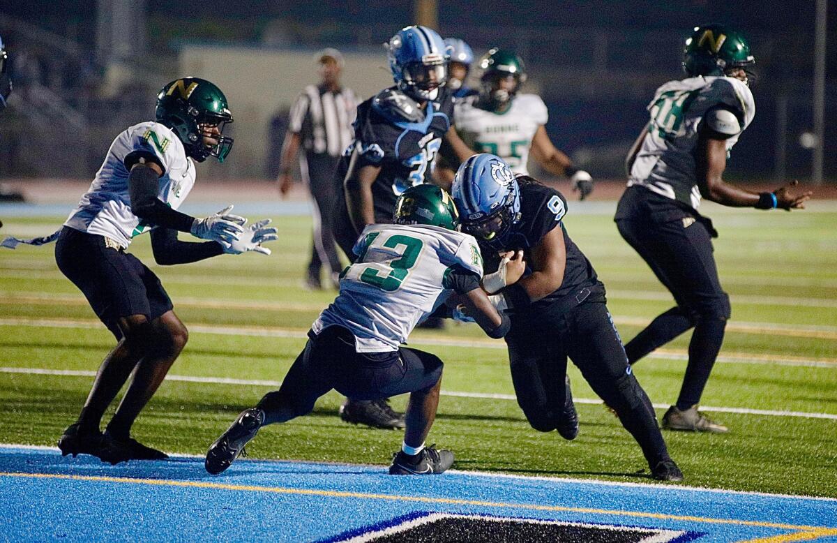 Carson fullback Brendan Fautua Leomiti scores a touchdown past Narbonne safety Triston Thomas.