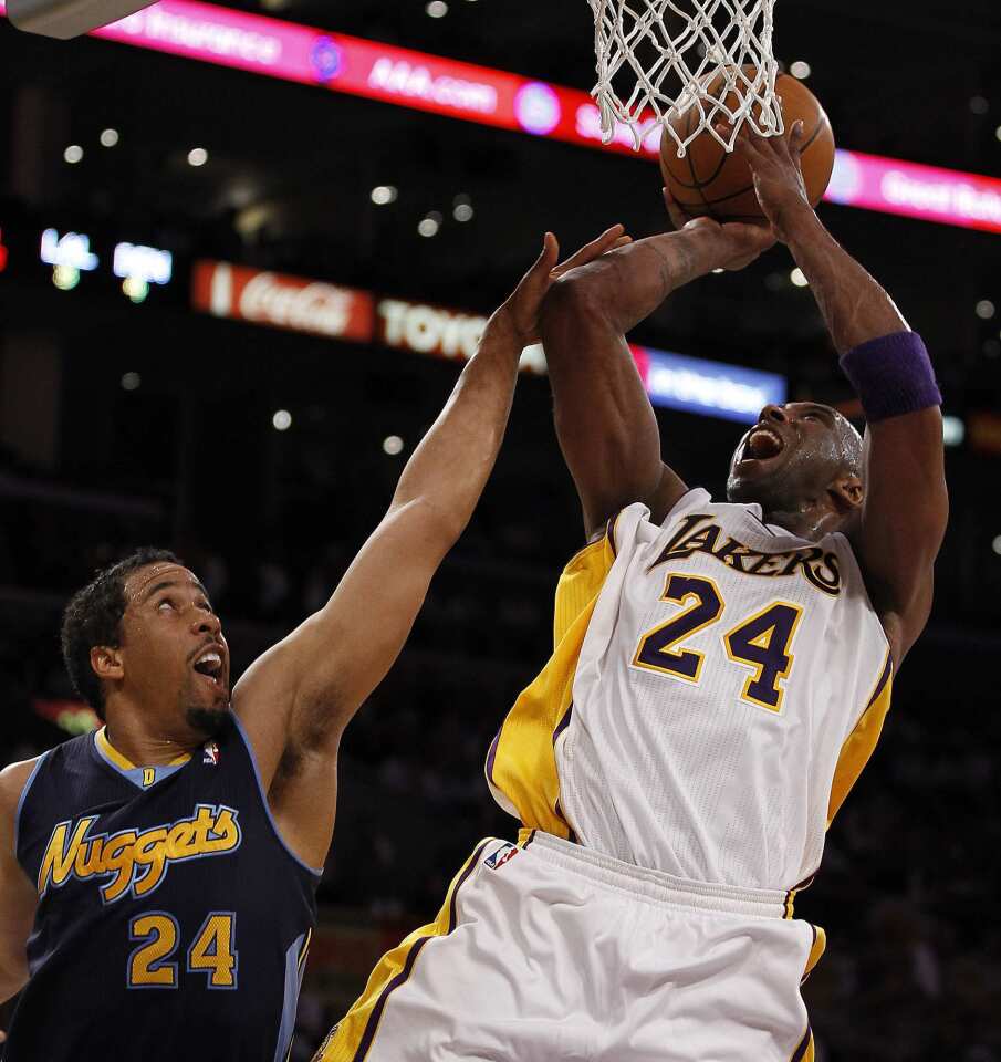 Lakers guard Kobe Bryant, who finished with a game-high 31 points, is fouled by Nuggets point guard Andre Miller in the fourth quarter Sunday afternoon at Staples Center during Game 1 of their first-round playoff series.