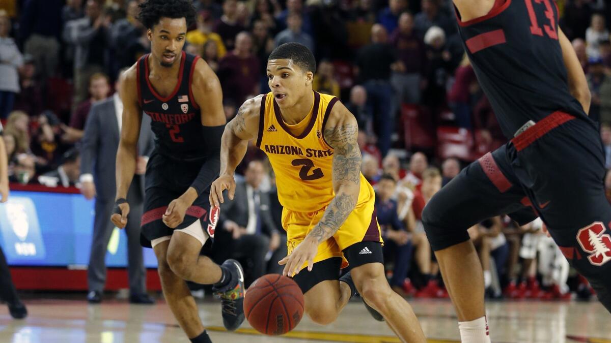 Arizona State guard Rob Edwards (2) drives between Stanford's Bryce Wills (2) and Oscar da Silva (13) during the second half on Wednesday in Tempe, Ariz.
