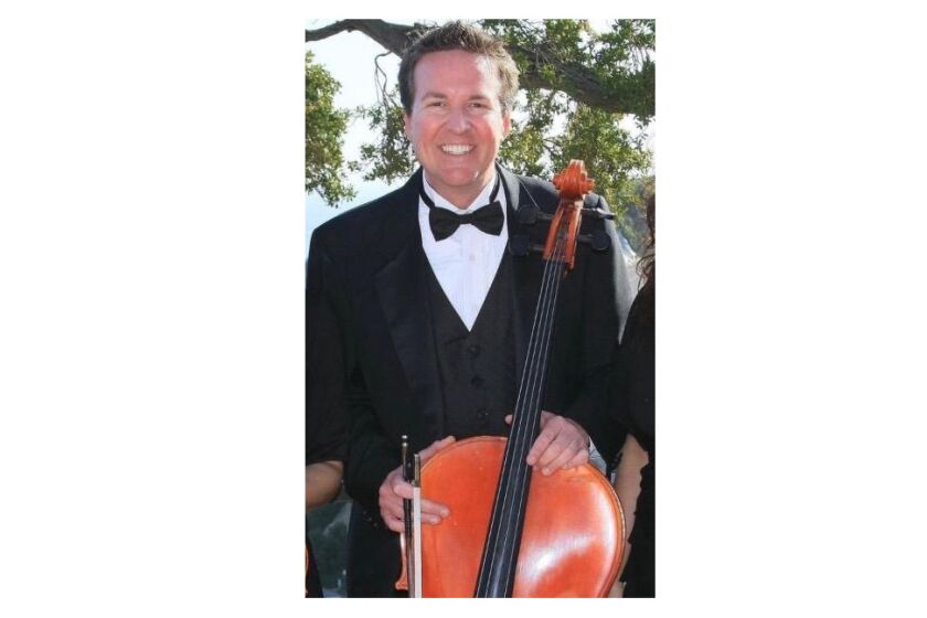 Newland Elementary School principal and professional cellist Chris Christensen poses for a photo at a gig.