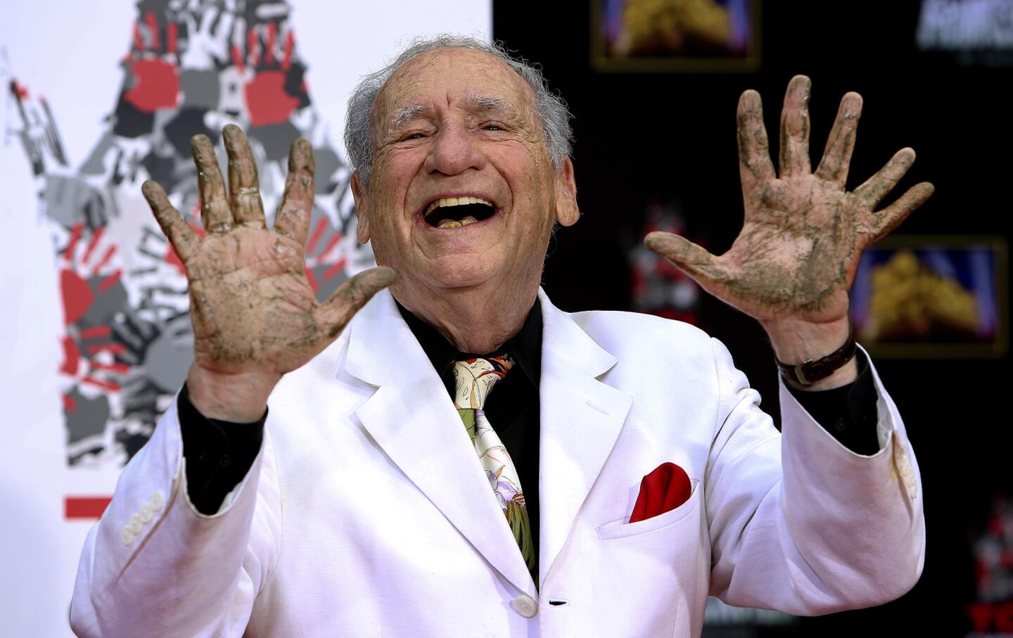Mel Brooks displays his hands, including a fake extra finger, after he placed them in concrete during a ceremony at the TCL Chinese Theatre in Hollywood.