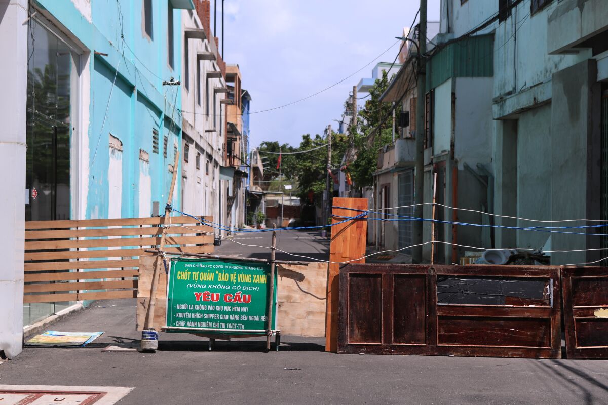 An alley is barricaded with door panels in Vung Tau, Vietnam.