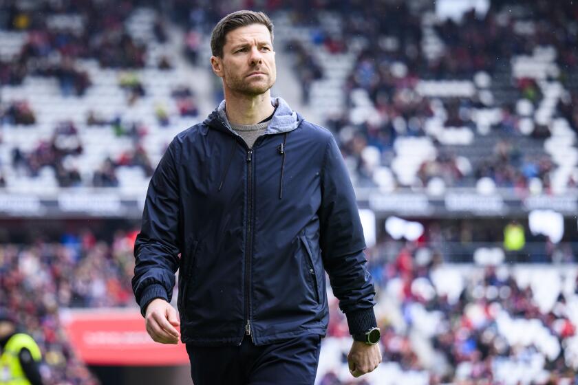 Leverkusen coach Xabi Alonso stands before the Bundesliga soccer match between Bayer Leverkusen and SC Freiburg at the Europa-Park Stadium in Freiburg im Breisgau, Germany, Sunday March 17, 2024. (Tom Weller/dpa via AP)