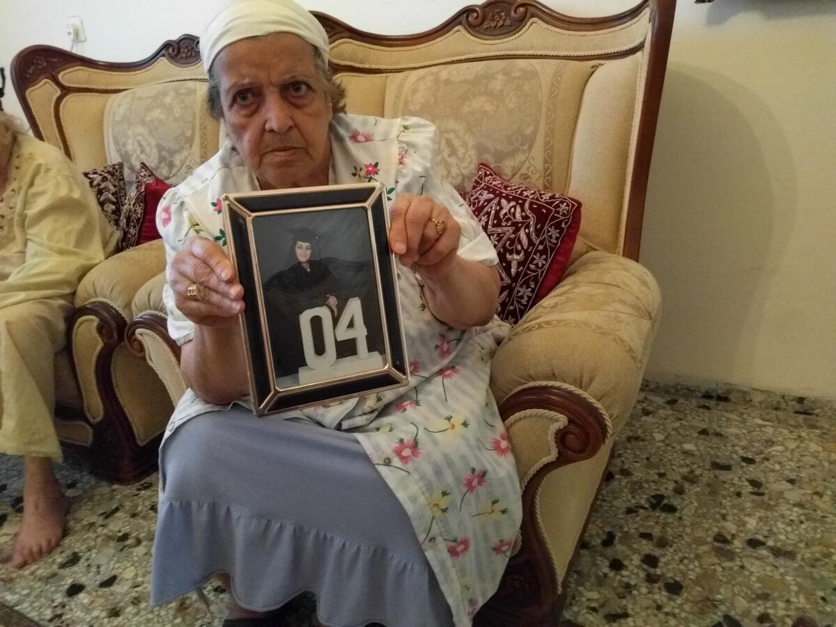 Mona Salman holds a photo of her niece, Noor Salman, the widow of Orlando gunman Omar Mateen. The aunt was photographed in her home in the West Bank on June 16, 2016.