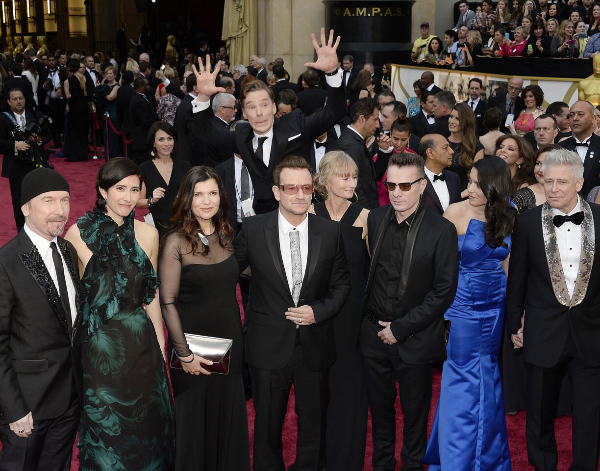 Cumberbatch is also known for photo bombing stars on the red carpet. Here, he jumps into a photo of U2 being taken at the 2014 Academy Awards.