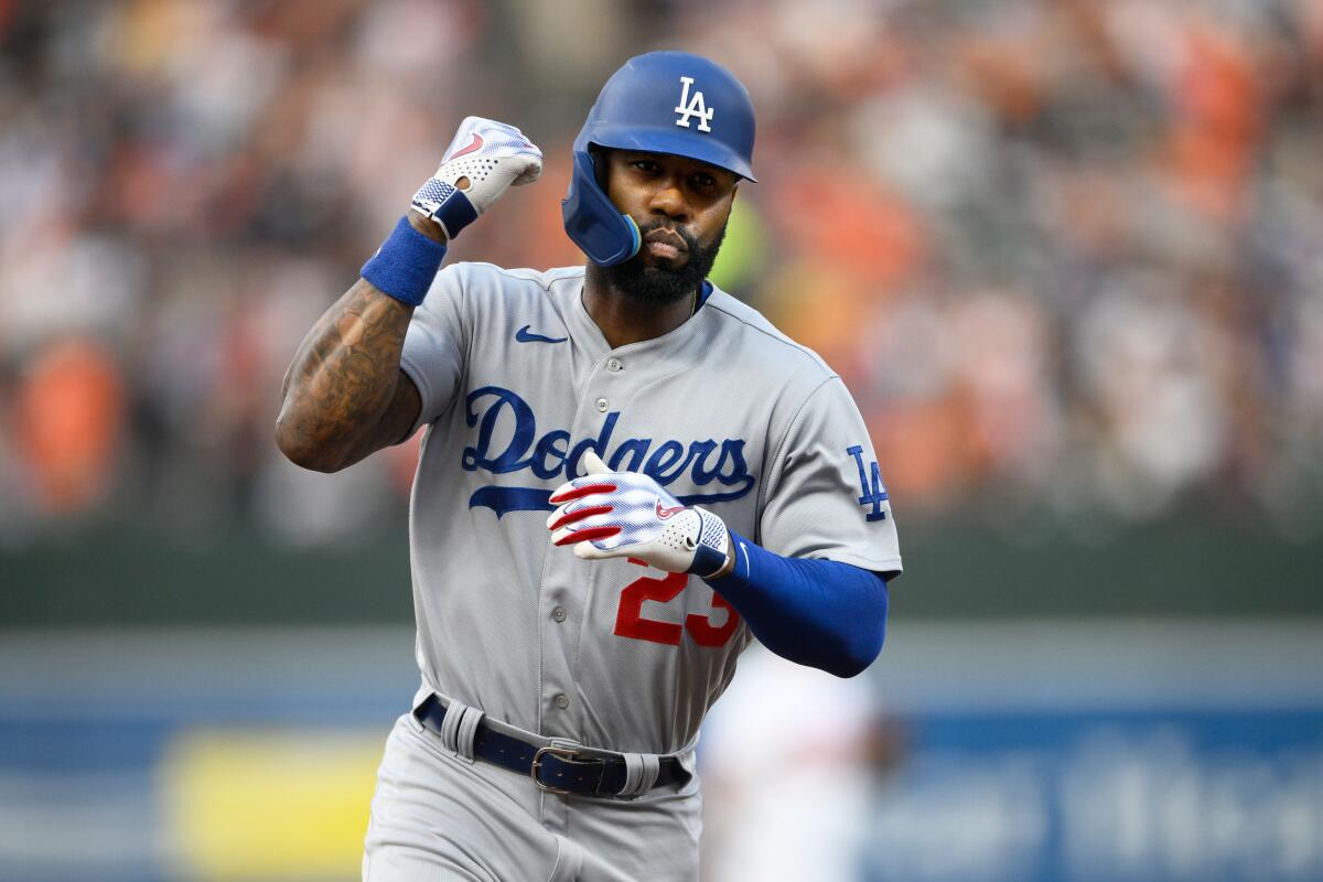 Dodgers' Jason Heyward raises his right fist after hitting a home run.