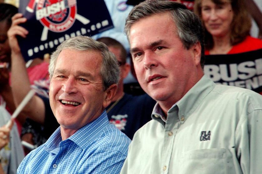 President George W. Bush with his brother. then-Florida Gov. Jeb Bush, at a campaign rally in October 2004.