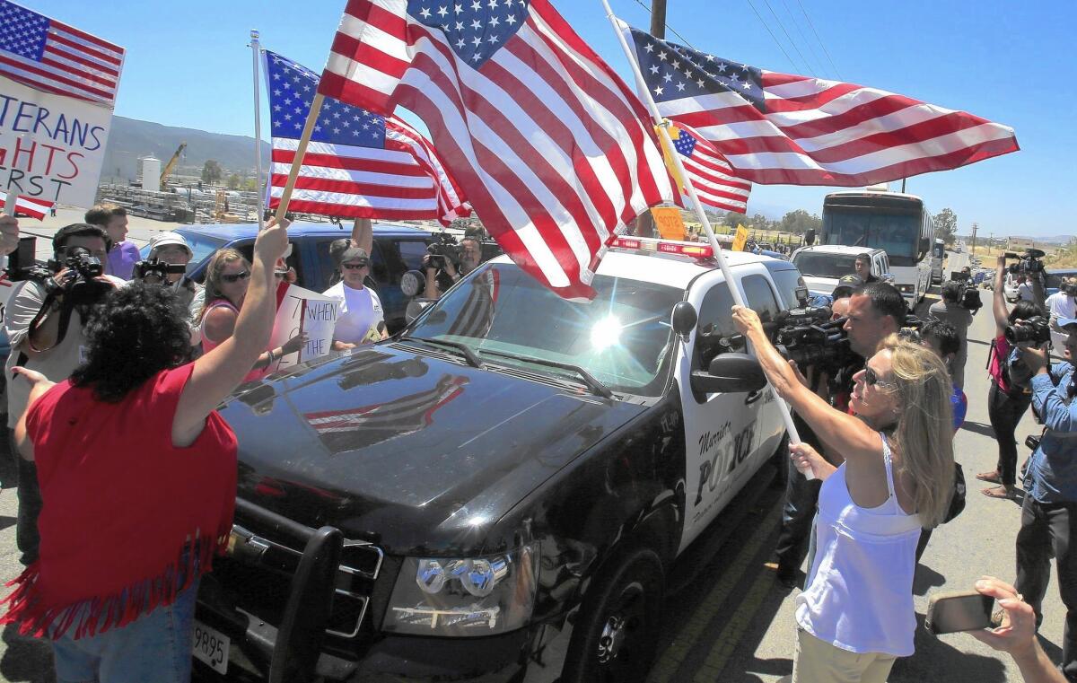 Protesters favoring stricter immigration enforcement turn away busloads of recently arrived women and children near a Border Patrol processing station in Murrieta last summer.