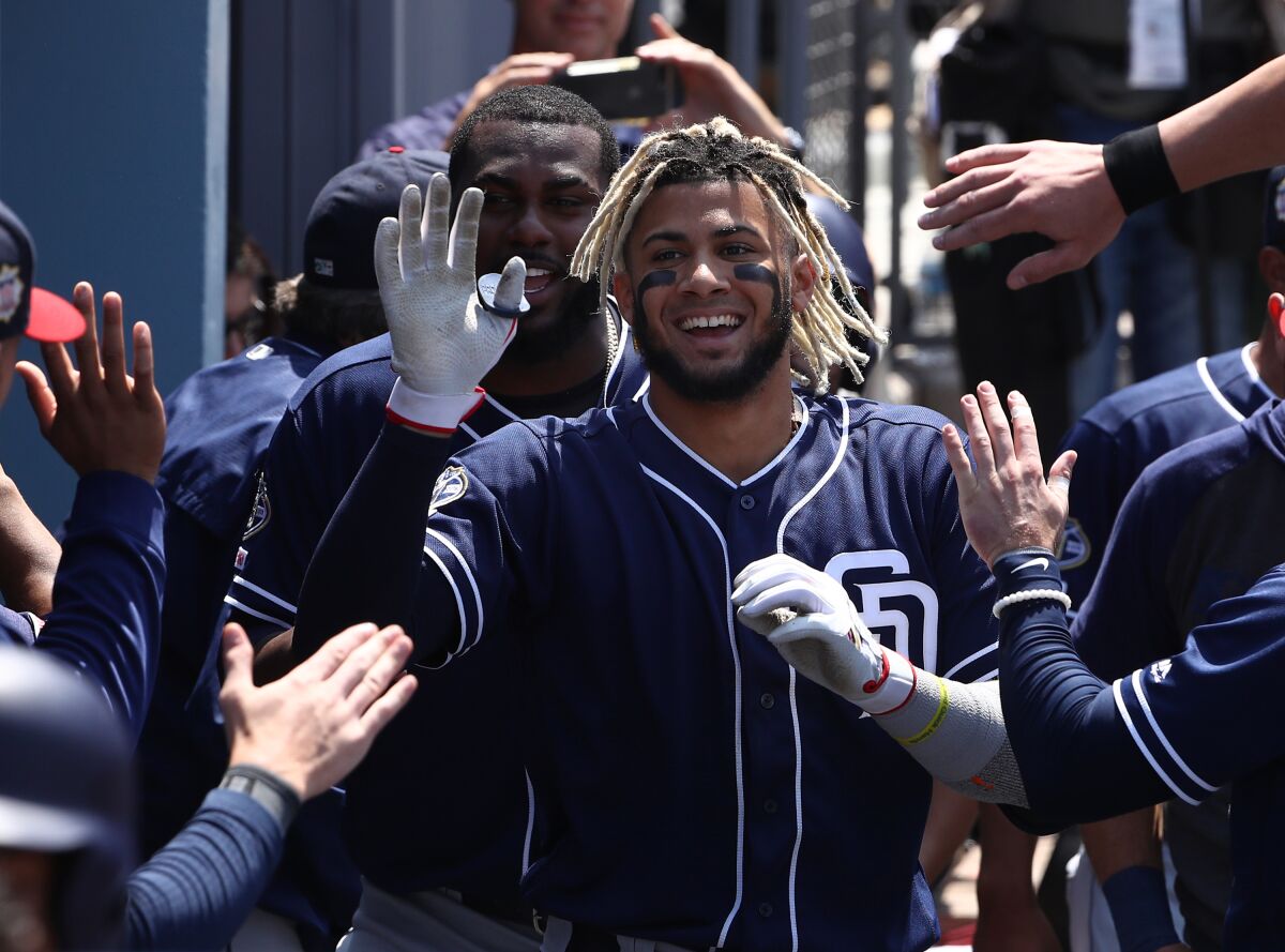 Fernando Tatis Jr. celebrates with Padres teammates after hitting one of his two home runs against the Dodgers on July 7.