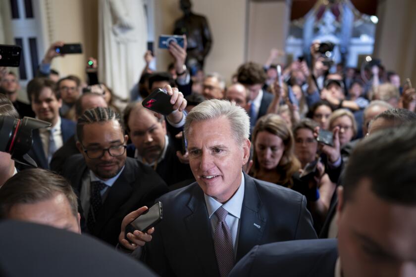 Speaker of the House Kevin McCarthy, R-Calif., is surrounded by press and police on the way to the chamber, at the Capitol in Washington, Tuesday, Oct. 3, 2023. McCarthy’s ability to remain in leadership is now seriously at risk after the House voted to move ahead with an effort by hard-right Republican critics to oust him. Tuesday’s narrow vote was forced by McCarthy’s chief rival, Rep. Matt Gaetz of Florida. (AP Photo/J. Scott Applewhite)