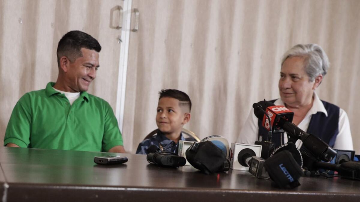 Omar Marino Dominguez Mejia and his son, Arin, are joined at a news conference by Sister Norma Pimentel at the Basilica of Our Lady of San Juan del Valle in San Juan, Texas.