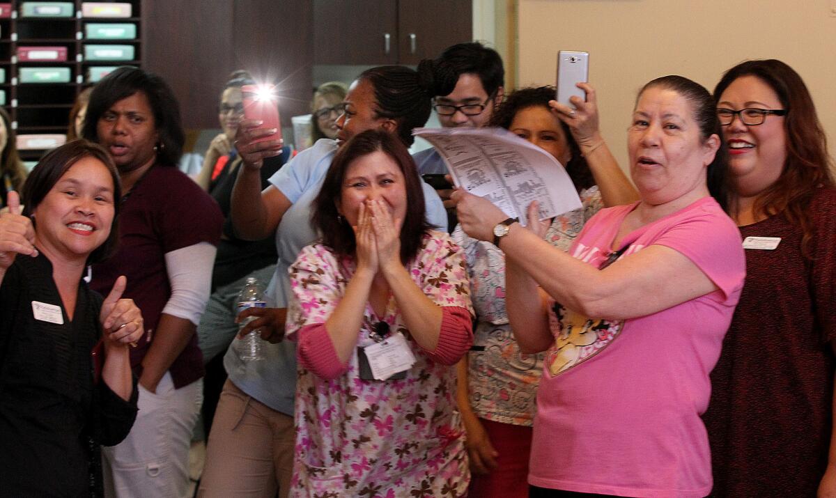 Workers at Park Avenue Healthcare & Wellness Centre in Pomona celebrate their colleague's Powerball lottery "win." Their elation turned to sadness when they learned they were victims of a hoax.