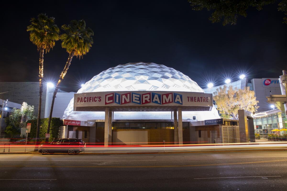 Traffic blurs by a boarded-up Cinerama Dome of the ArcLight Cinemas on Sunset Blvd, in the heart of Hollywood, CA