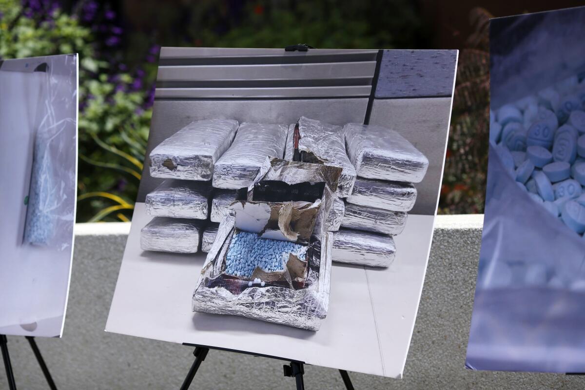 A photograph is displayed on an easel of packages of drugs
