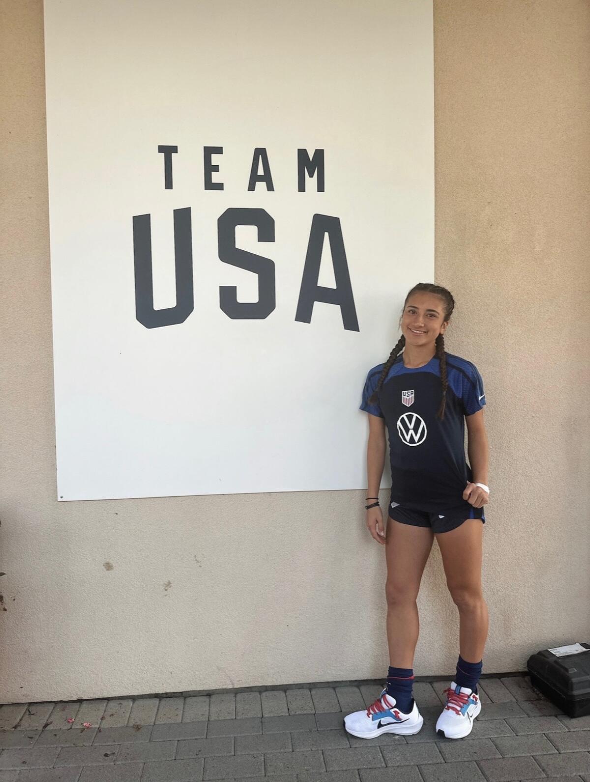 Etiwanda junior Scottie Antonucci poses for a photo in front of a Team USA banner.