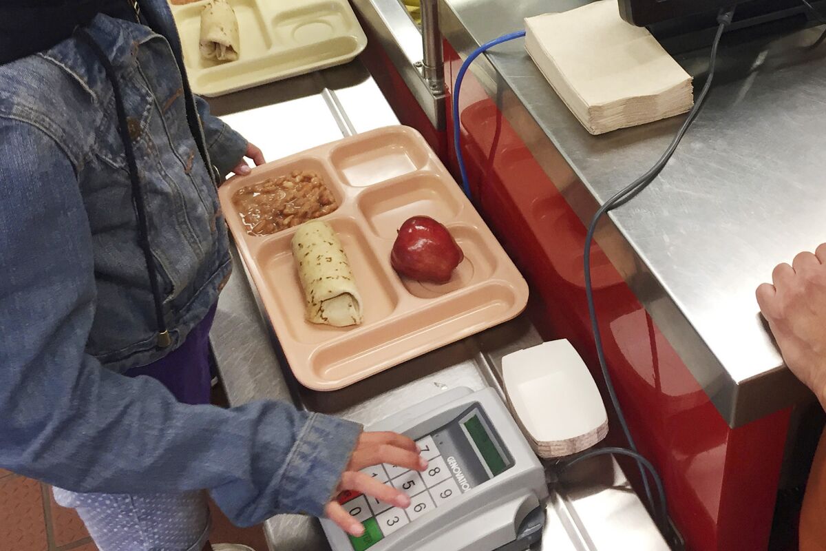 In this May 4, 2017 file photo, a third-grader gets a healthy school lunch.