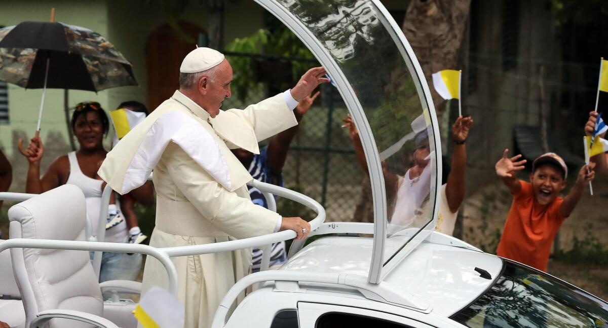 Pope Francis waves on his way to the village of El Cobre, Cuba, on Sept. 21. Pope Francis is in Cuba as part of a historic nine-day trip that will also take him to the United States this week.
