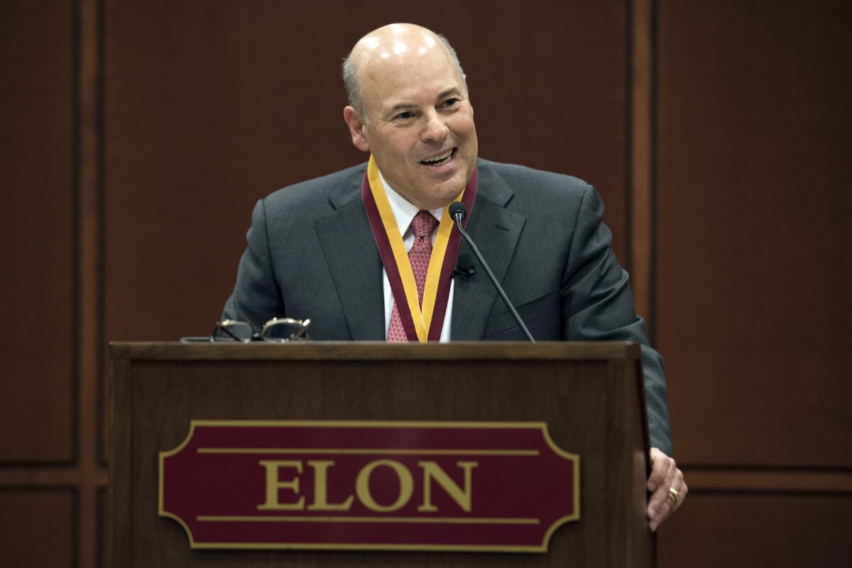 FILE - In this March 1, 2017, file photo, then Elon Trustee Louis DeJoy is honored with Elon's Medal for Entrepreneurial Leadership in Elon. N.C. U.S. Sen. Joe Manchin and union officials say the U.S. Postal Service is considering closing post offices across the country, sparking worries ahead the anticipated surge of mail-in ballots in the 2020 elections. Manchin on Wednesday, July 29, 2020 said he has received numerous reports from post offices and colleagues about service cuts or looming closures in West Virginia and elsewhere, prompting him to send a letter to Postmaster General Louis DeJoy asking for an explanation. (Kim Walker/Elon University via AP, File)