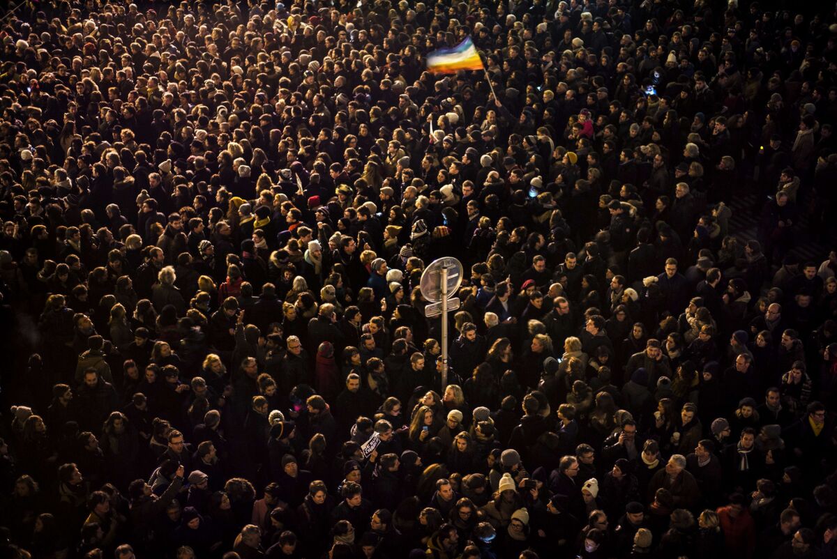 A crowd gathers in Lyon, France, after Wednesday's shooting in Paris.