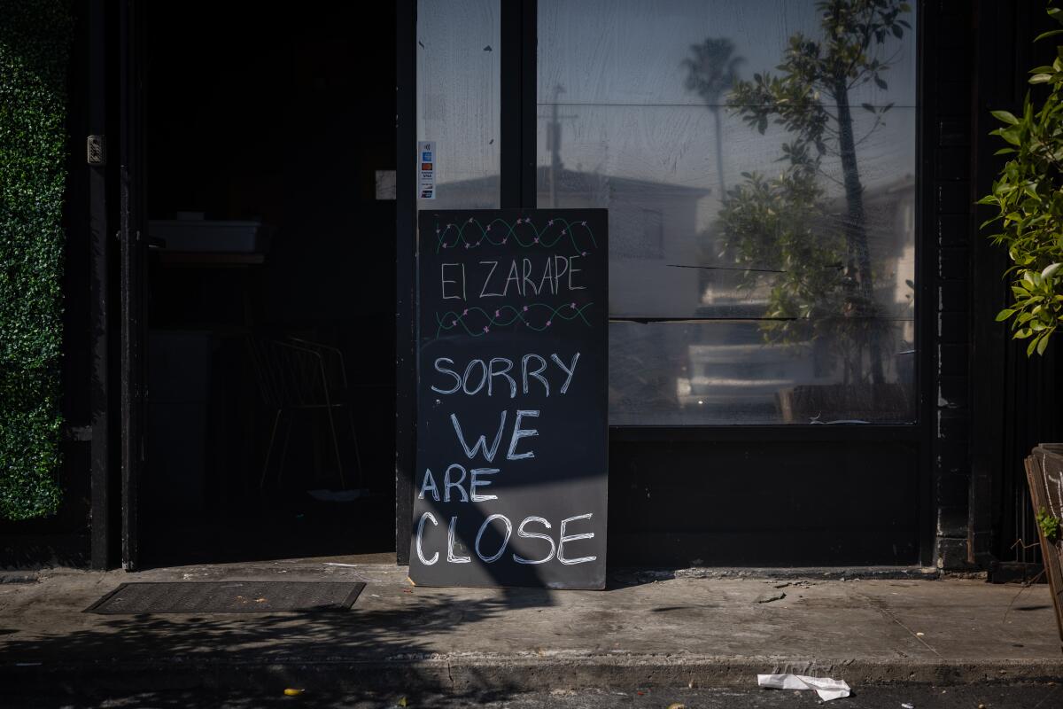 A sign outside El Zarape tells customers that the restaurant is closed.